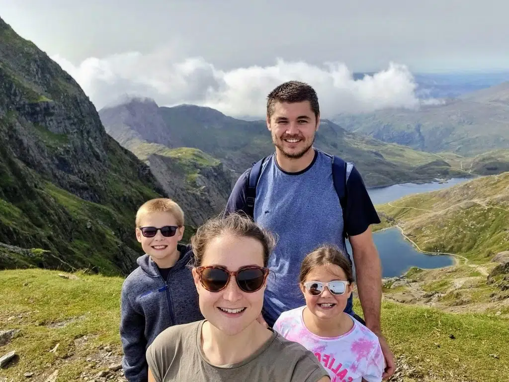 Climbing Snowdon with Kids, frugal mum Snowdon Ranger Path guide, photo of family at summit with view