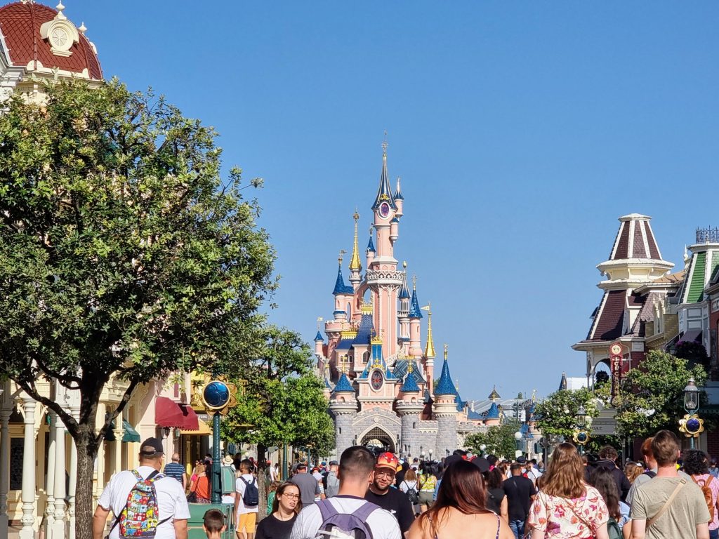 disneyland paris guide, review, frugal mum family photo, main street, busy, people, castle behind