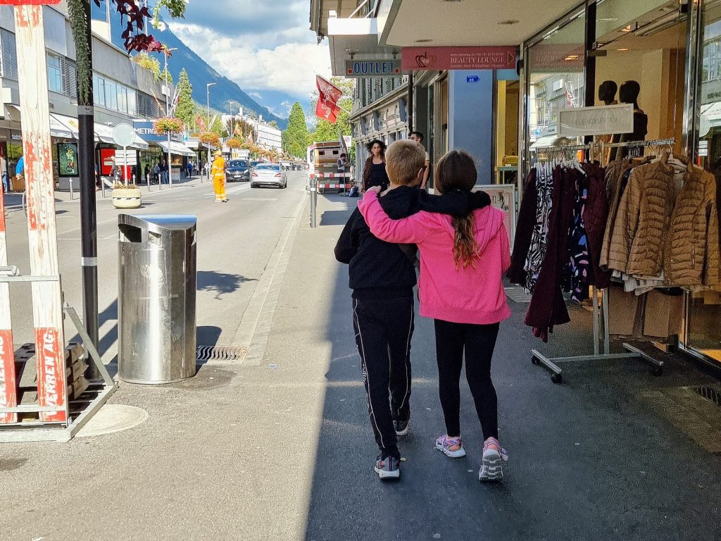 Visit Switzerland Interlaken on a budget with kids, family holiday guide itinerary, city centre, frugal mum children, shops photo