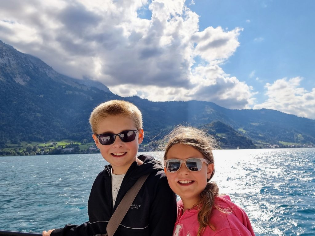 Visit Switzerland Interlaken on a budget with kids, family holiday guide itinerary, boat ride, frugal mum children, lake thun, photo
