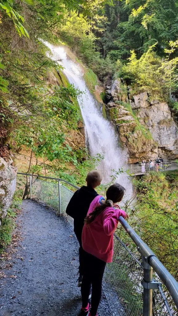 Switzerland with kids, Giessbach Falls Waterfalls Review, Lake Brienz, photo of frugal mum children by waterfall