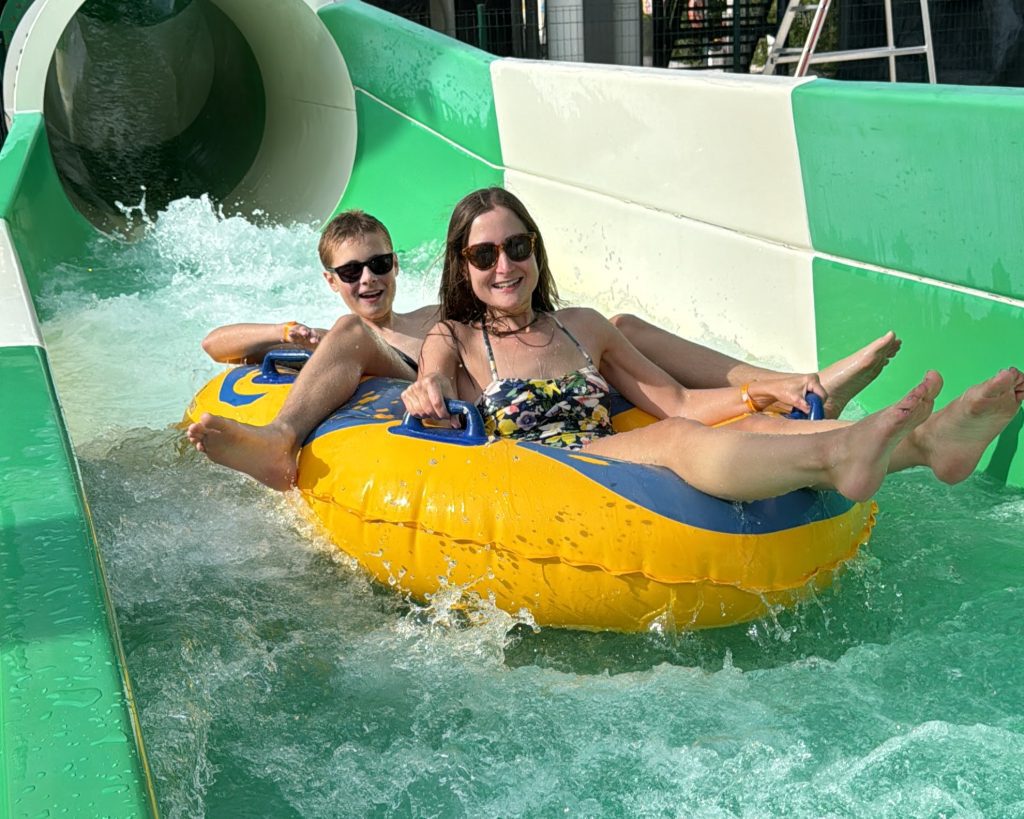 photo of frugal mum and child on water slide