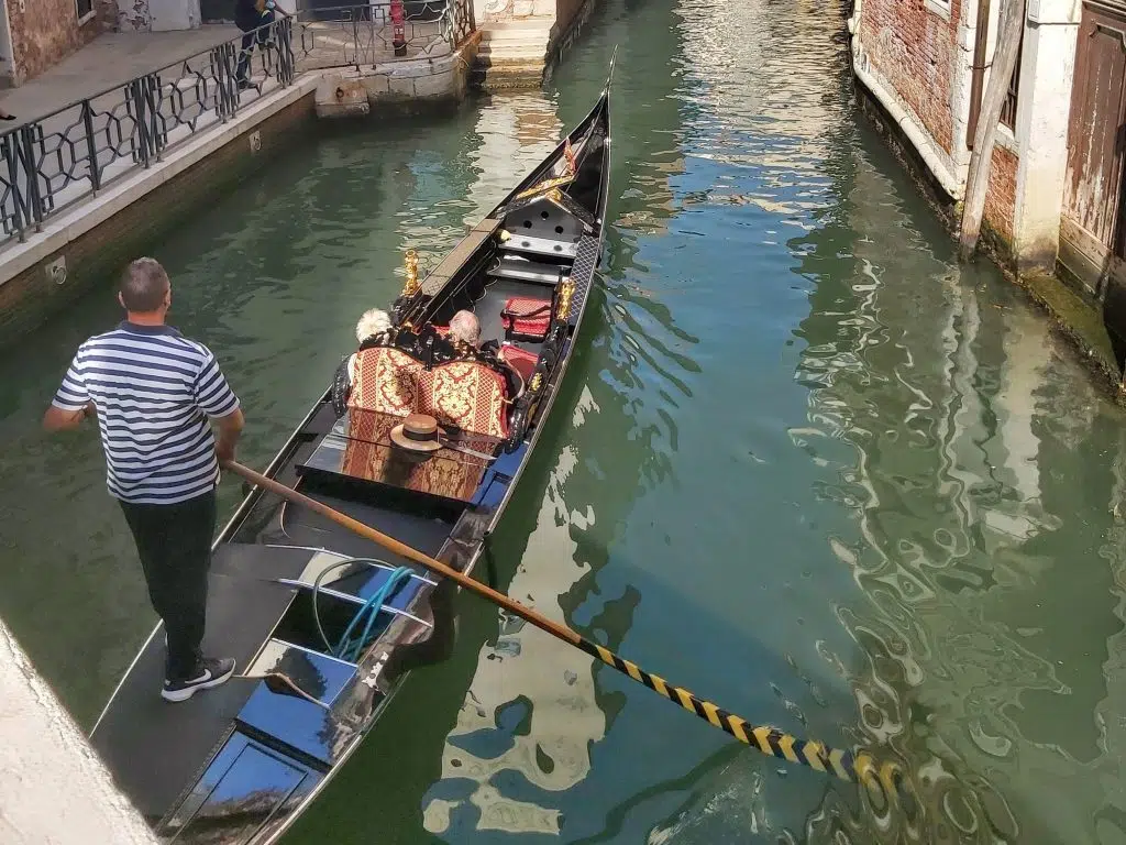 photo of venice canal with gondola