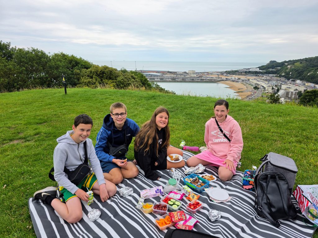 Visiting Dover Castle with kids, a fun family day out guide, frugal mum photo of children having picnic