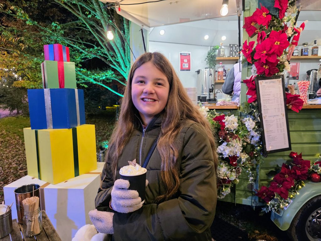 Kent with Kids, Frugal Mum Bedgebury Christmas Lights family guide & review, photo of girl with hot chocolate