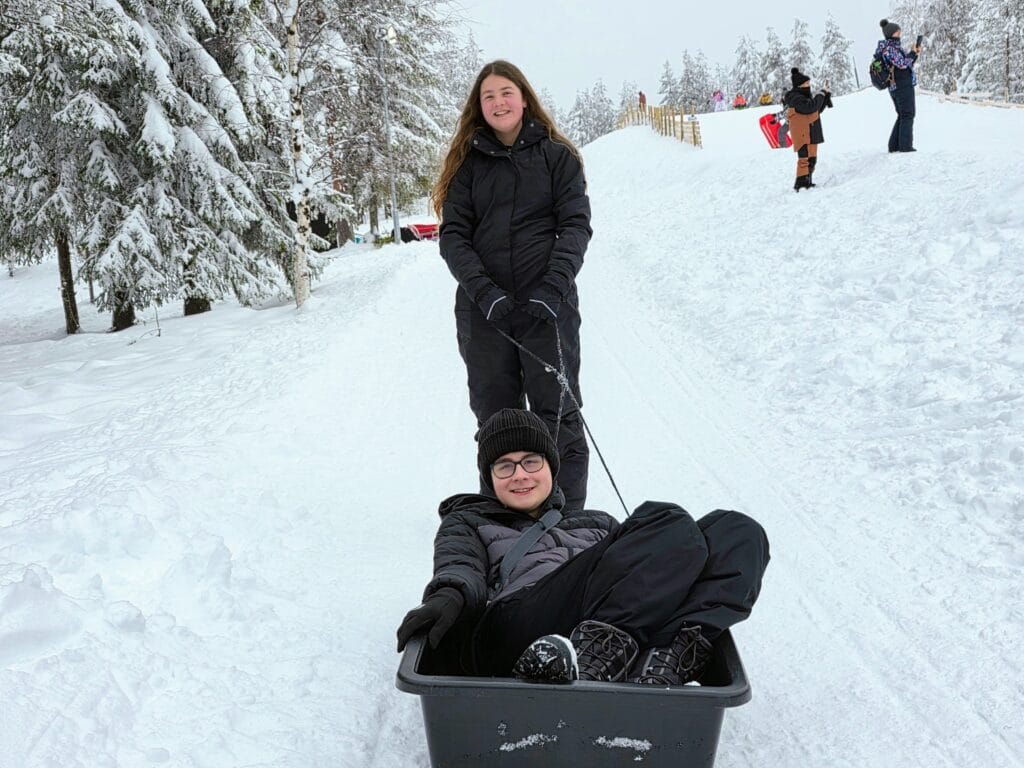 3 days in Rovaniemi with kids the perfect lapland family itinerary, frugal mum finland travel guide, photo of kids sledging