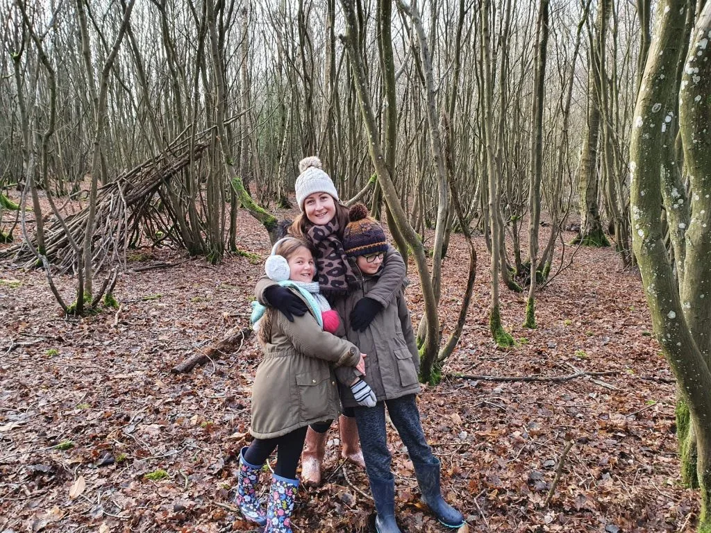 frugal mum with children in woods, wrapped up, winter, DIY family christmas without money on a budget