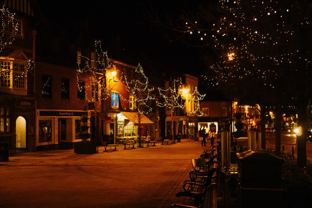 wintery, night time high street decorated with christmas lights