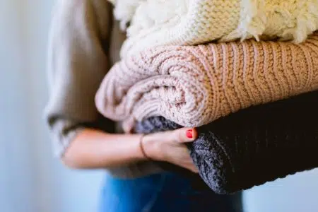 women holding jumpers, frugal mum aldi review, detergent