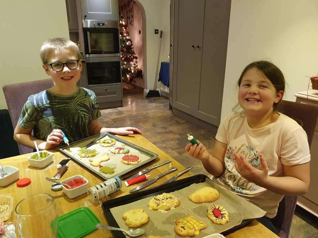 frugal mum children baking in kitchen, christmas biscuits, DIY family christmas on a budget without money tips