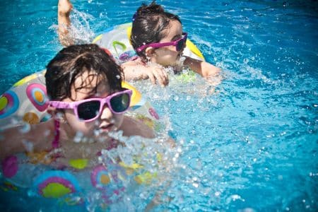 children swimming in pool