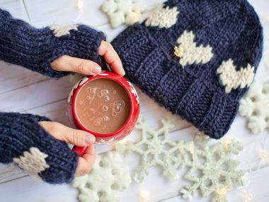hand knitted gloves and hat, lady holding hot chocolate
