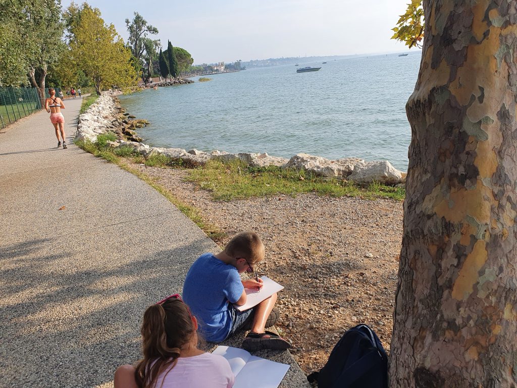 How to home educate on a budget, UK discounts, freebies & tips for travel, resources & days out guide, photo of frugal mum children in lake garda