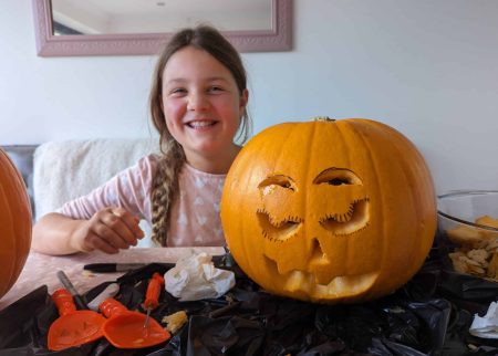 frugal mum child carving pumpkin