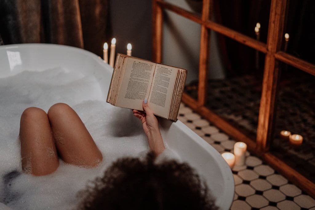 woman reading book relaxing in the bath, Homemade DIY Christmas hamper ideas on a budget