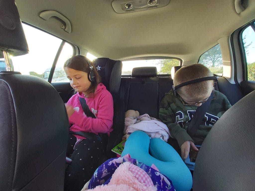 road trip essentials with kids, frugal mum photo children in car